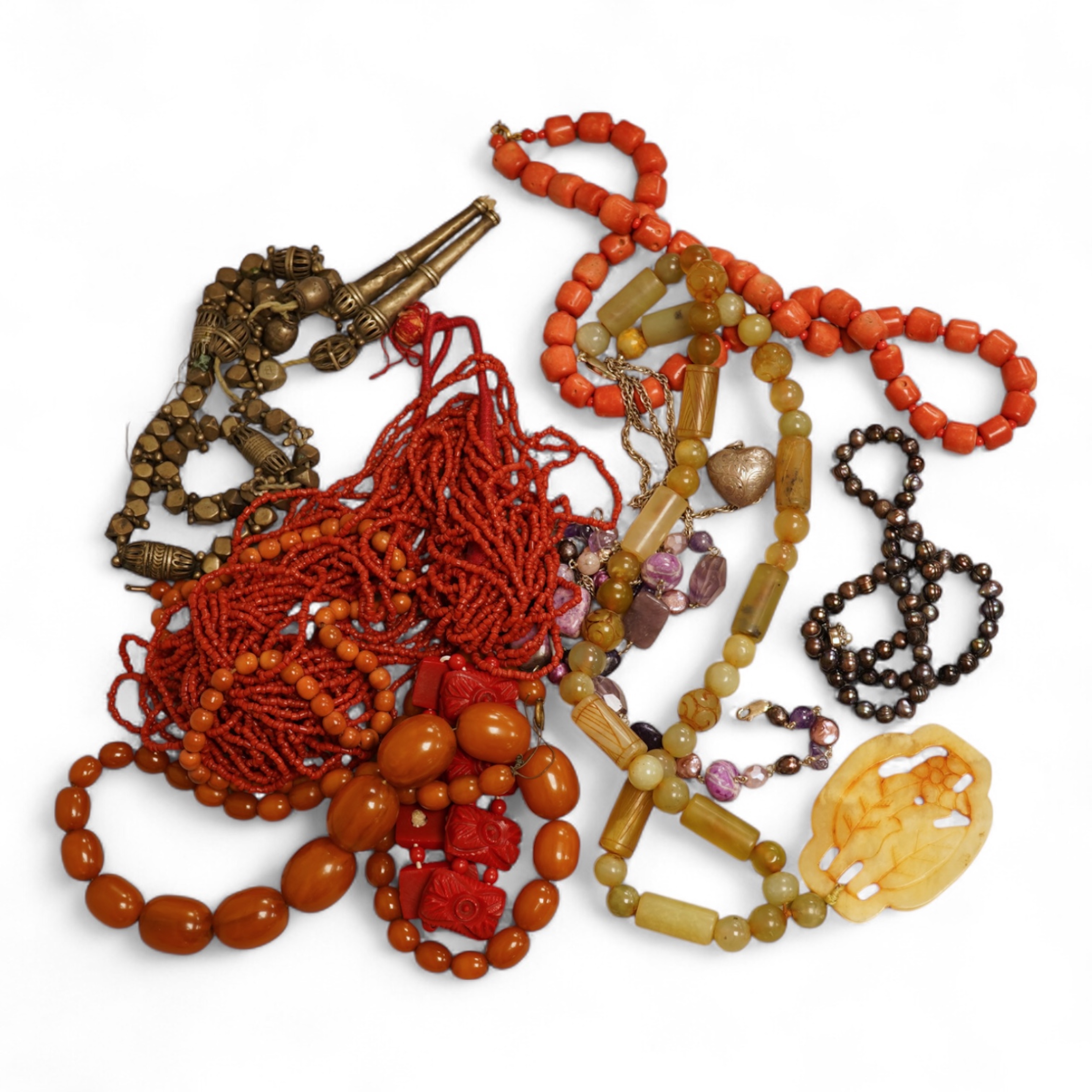 A small group of sundry jewellery including a simulated amber necklace and a multi strand coral bead necklace, etc.